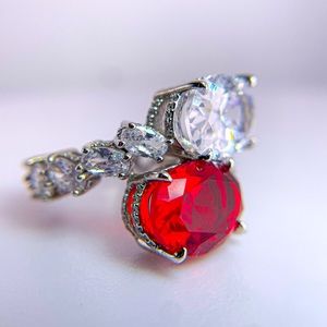 Silver Toned Ring with Cubic Zirconia and Red Stone Oval and Side Stones.